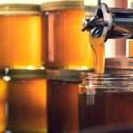Filling up jars with honey
